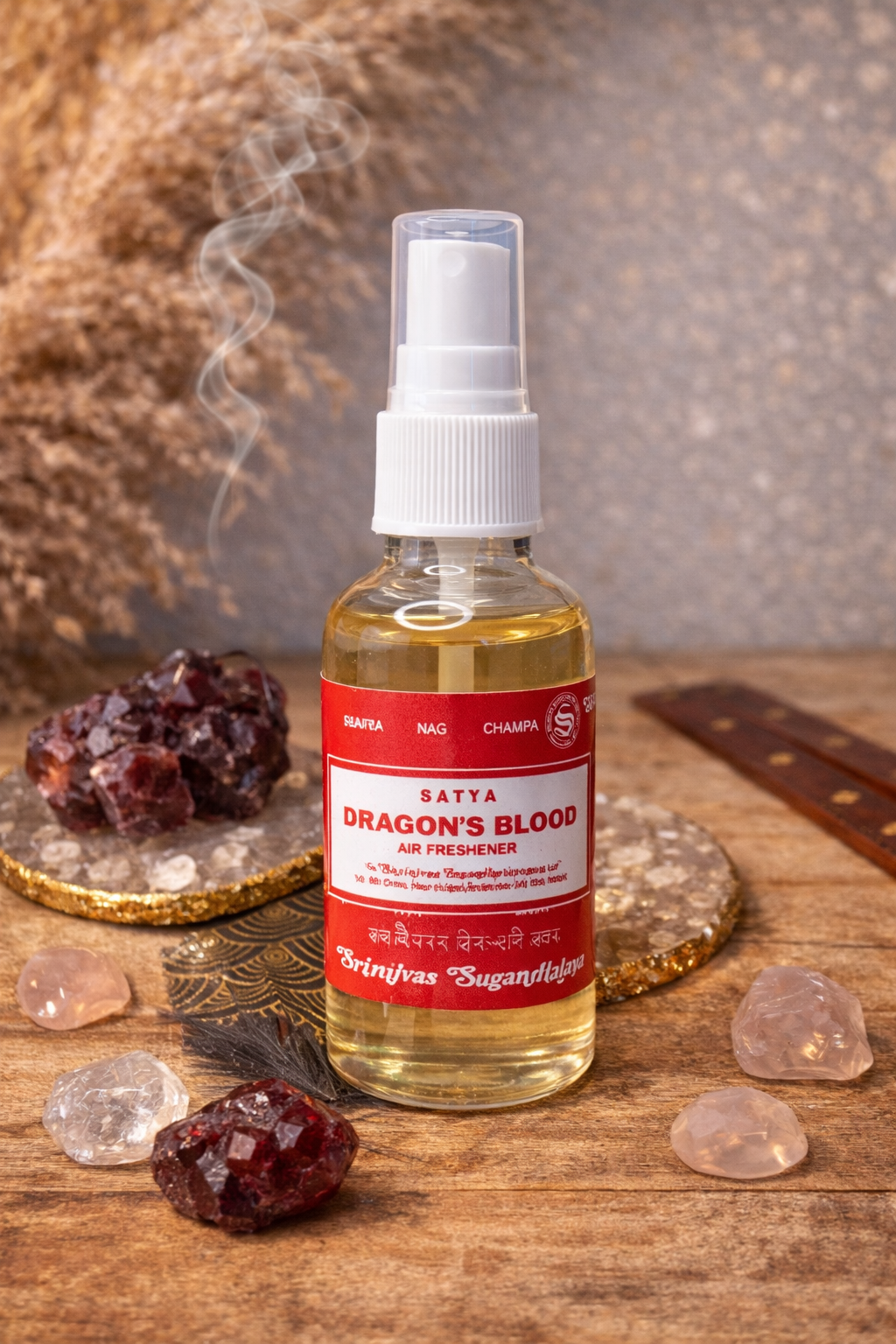 Spray parfumé Satya Sang de Dragon posé sur un support décoratif noir et or, entouré de pierres naturelles et pétales rouges, dans une ambiance spirituelle et chaleureuse.